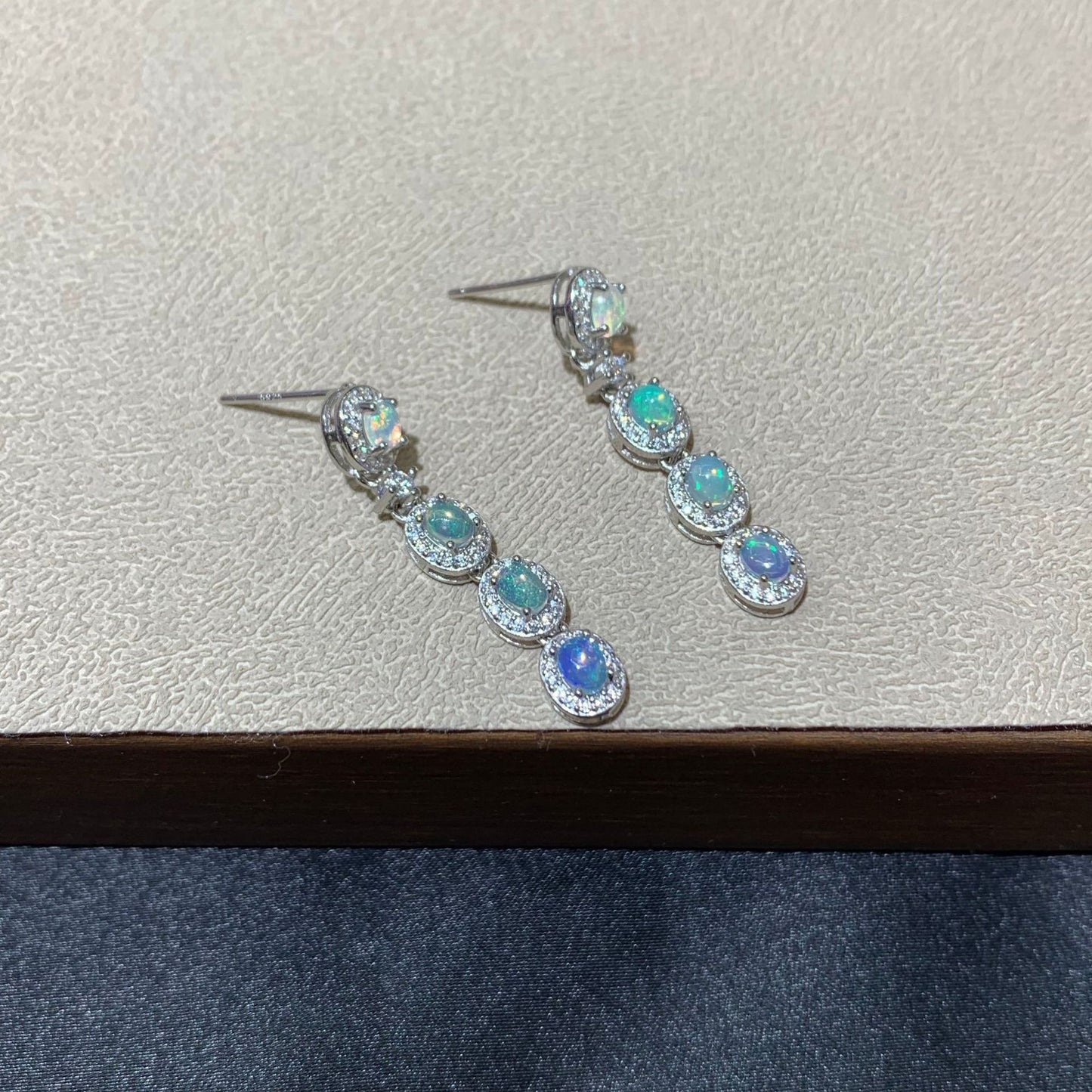 925 sterling silver opal drop earrings featuring four oval opals surrounded by sparkling cubic zirconia halo settings