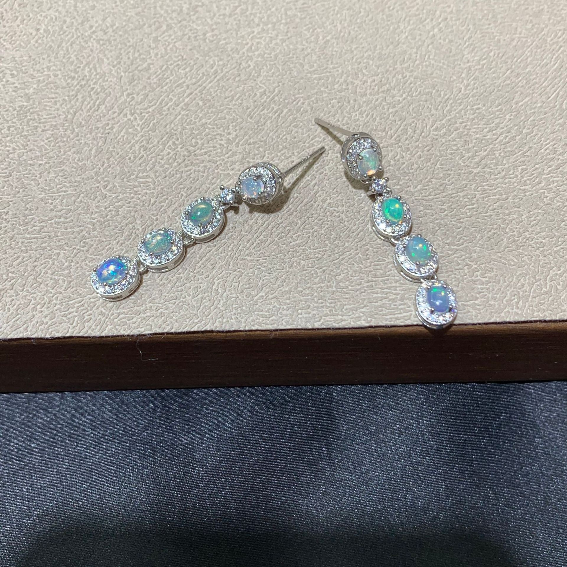 925 sterling silver opal drop earrings featuring four oval opals surrounded by sparkling cubic zirconia halo settings